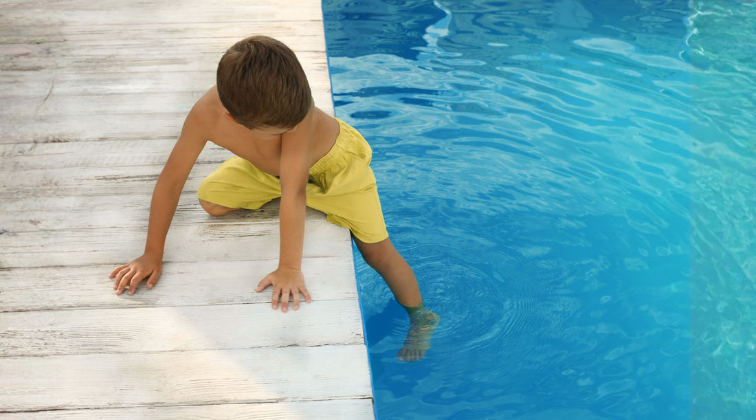 Child walking on wet pool deck in Singapore