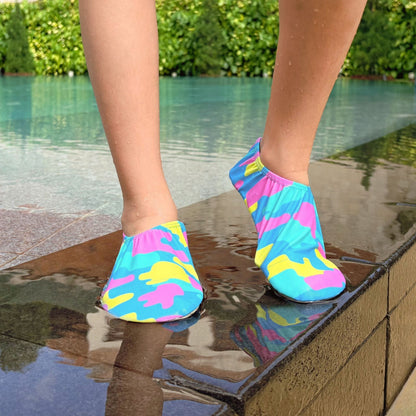 Non-slip water shoes with ice cream pattern worn by a person standing on a Singapore poolside.