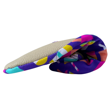 Folded non-slip water socks with colorful popsicle pattern and beige grip sole on a transparent background.