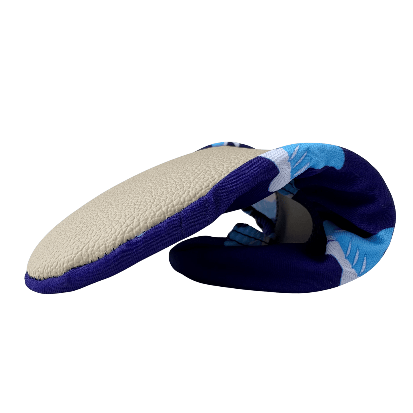 Folded non-slip water socks with navy shark pattern and beige grip sole on a transparent background.